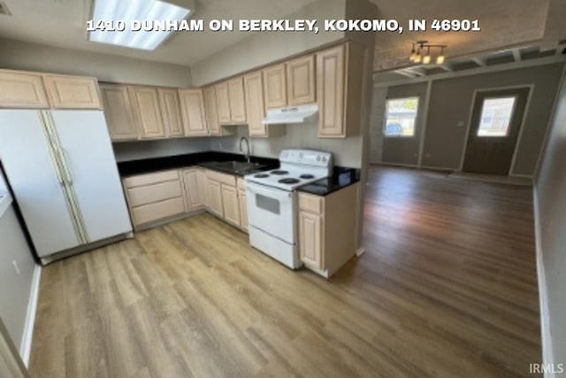 1410 Dunham On Berkley, Kokomo, IN 46901 - kitchen featuring white appliances, under cabinet range hood, light wood-type flooring, dark countertops, and light brown cabinetry