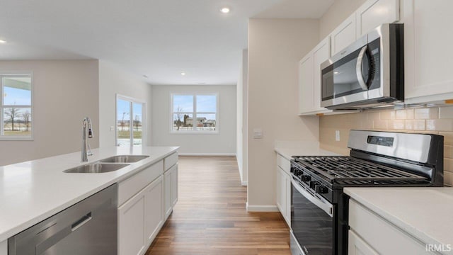 5103 Buffay Ct, New Haven, IN 46774 - kitchen with stainless steel appliances, decorative backsplash, light wood-style floors, light countertops, and recessed lighting