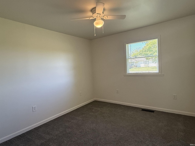1501 S Wheeling St, Jonesboro, IN 46938 - spare room featuring dark colored carpet and a ceiling fan