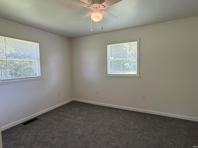 1501 S Wheeling St, Jonesboro, IN 46938 - empty room featuring dark colored carpet and a ceiling fan