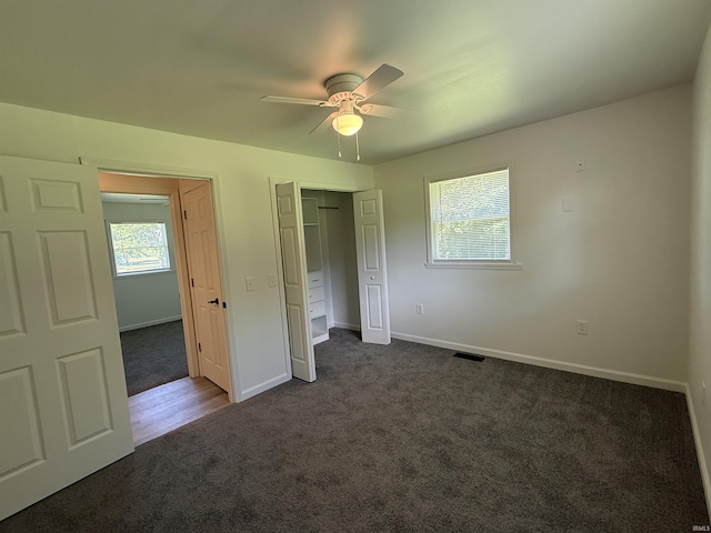 1501 S Wheeling St, Jonesboro, IN 46938 - unfurnished bedroom featuring dark colored carpet, a ceiling fan, and a closet