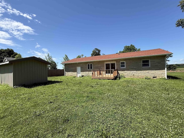 1501 S Wheeling St, Jonesboro, IN 46938 - back of property with stone siding, a wooden deck, and a storage unit