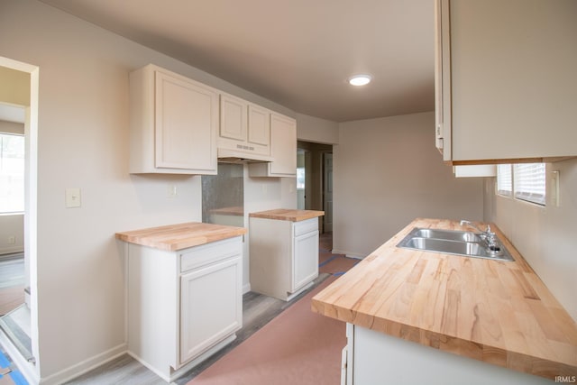 1210 W Hickory St, Union City, IN 47390 - kitchen with butcher block countertops, healthy amount of natural light, and white cabinetry