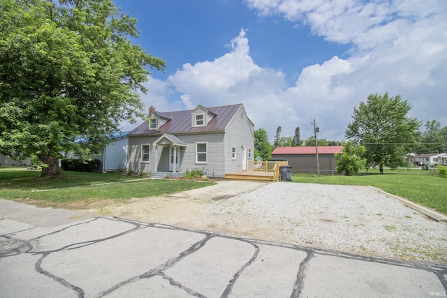1210 W Hickory St, Union City, IN 47390 - view of front of property featuring gravel driveway, a front yard, a metal roof, a standing seam roof, and a chimney