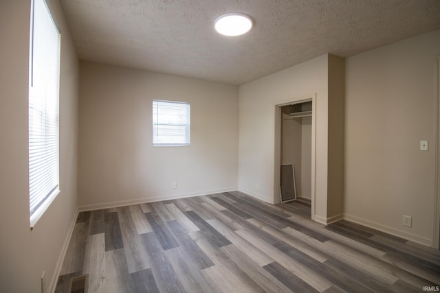 1210 W Hickory St, Union City, IN 47390 - unfurnished bedroom featuring wood finished floors, a textured ceiling, and a closet