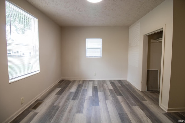 1210 W Hickory St, Union City, IN 47390 - unfurnished bedroom with a textured ceiling and wood finished floors