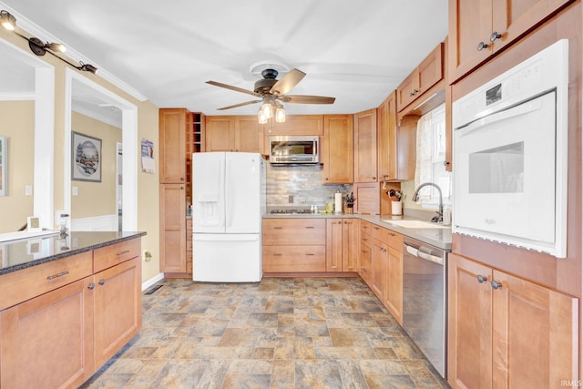1803 Linwood Dr, Bedford, IN 47421 - kitchen featuring stainless steel appliances, stone finish floors, a ceiling fan, tasteful backsplash, and dark stone counters