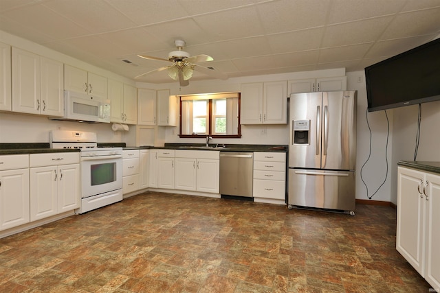 1765 E Old Kokomo Rd, Marion, IN 46953 - kitchen featuring appliances with stainless steel finishes, dark countertops, ceiling fan, a paneled ceiling, and white cabinets