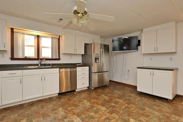 1765 E Old Kokomo Rd, Marion, IN 46953 - kitchen featuring appliances with stainless steel finishes, dark countertops, a ceiling fan, and white cabinetry