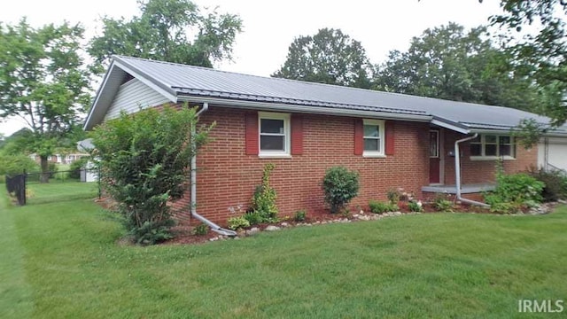 716 Kimmell Rd, Vincennes, IN 47591 - ranch-style house with brick siding, a garage, and a metal roof