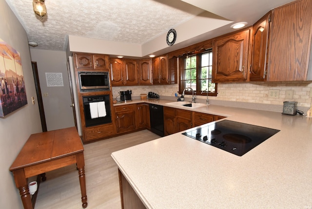 805 S James Ave, Fowler, IN 47944 - kitchen featuring black appliances, light wood-type flooring, backsplash, light countertops, and a textured ceiling