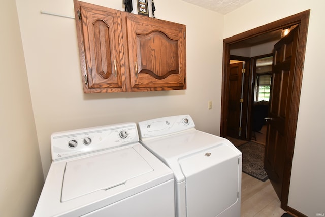 805 S James Ave, Fowler, IN 47944 - washroom with washer and dryer, cabinet space, and light wood-style flooring