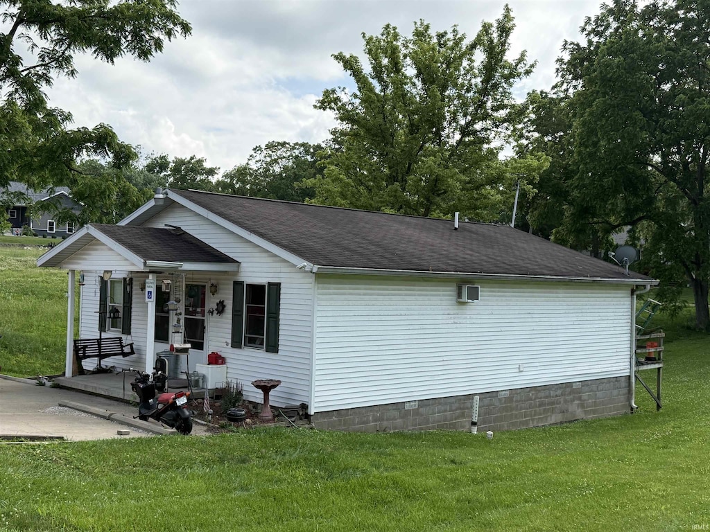 2415-2417 L St, Bedford, IN 47421 - view of side of property with a lawn, covered porch, crawl space, and roof with shingles