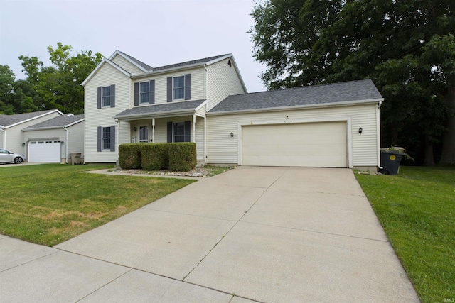 2233 Pine Creek Ct, South Bend, IN 46628 - view of front facade featuring a front lawn, an attached garage, and driveway
