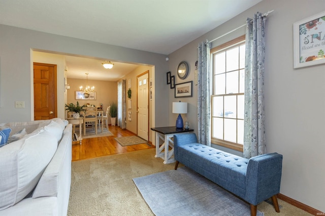 2233 Pine Creek Ct, South Bend, IN 46628 - living room with a chandelier, light carpet, and light wood-style floors