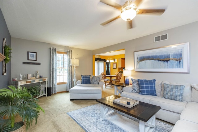 2233 Pine Creek Ct, South Bend, IN 46628 - living area with a chandelier, ceiling fan, and light carpet