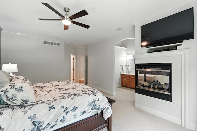118 Royal Crest Dr, Fort Wayne, IN 46814 - bedroom with crown molding, light colored carpet, a multi sided fireplace, arched walkways, and a ceiling fan