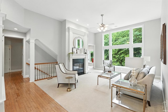 118 Royal Crest Dr, Fort Wayne, IN 46814 - living area with a ceiling fan, recessed lighting, wood-type flooring, a fireplace with flush hearth, and decorative columns