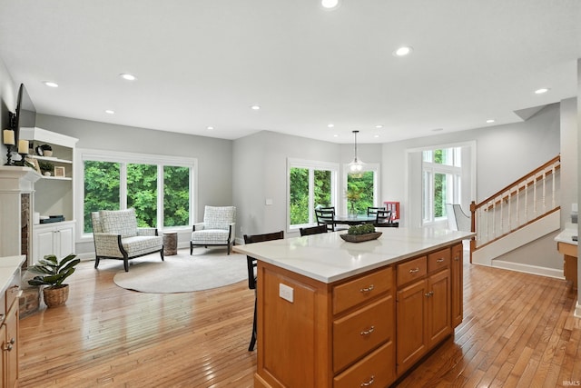 118 Royal Crest Dr, Fort Wayne, IN 46814 - kitchen with light wood finished floors, a center island, recessed lighting, a breakfast bar area, and pendant lighting