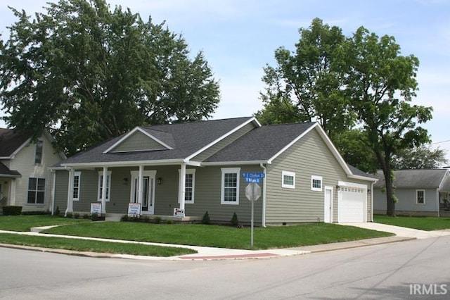 1001 E Clinton St, Frankfort, IN 46041 - view of front of house featuring driveway, covered porch, a garage, and a front lawn