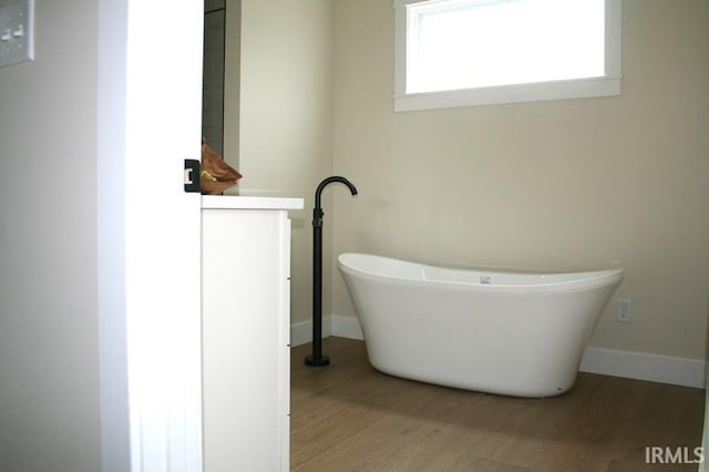1001 E Clinton St, Frankfort, IN 46041 - full bathroom featuring wood finished floors and a soaking tub
