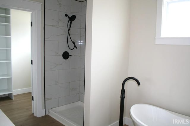 1001 E Clinton St, Frankfort, IN 46041 - bathroom with a shower stall, wood finished floors, and a freestanding bath