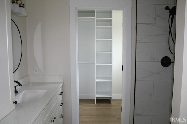1001 E Clinton St, Frankfort, IN 46041 - bathroom with vanity, wood finished floors, and a tile shower