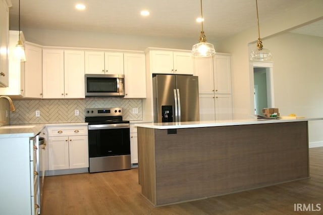 1001 E Clinton St, Frankfort, IN 46041 - kitchen featuring appliances with stainless steel finishes, backsplash, wood finished floors, white cabinets, and light countertops