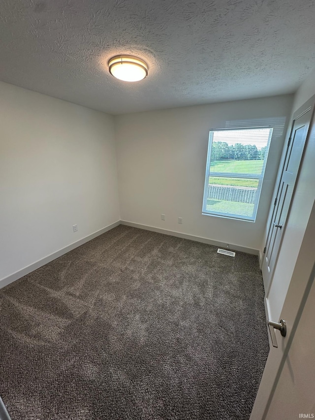 914 Braxton Dr N, Lafayette, IN 47909 - unfurnished room featuring dark colored carpet and a textured ceiling