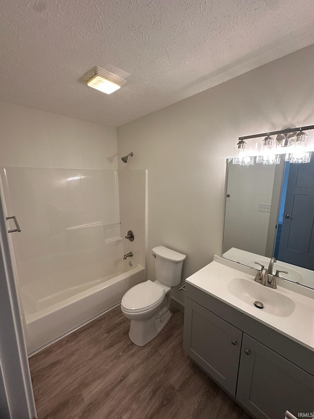 914 Braxton Dr N, Lafayette, IN 47909 - full bathroom with wood finished floors, a textured ceiling, shower / washtub combination, and vanity
