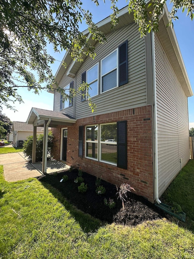 914 Braxton Dr N, Lafayette, IN 47909 - view of property exterior featuring brick siding, a patio, and a yard