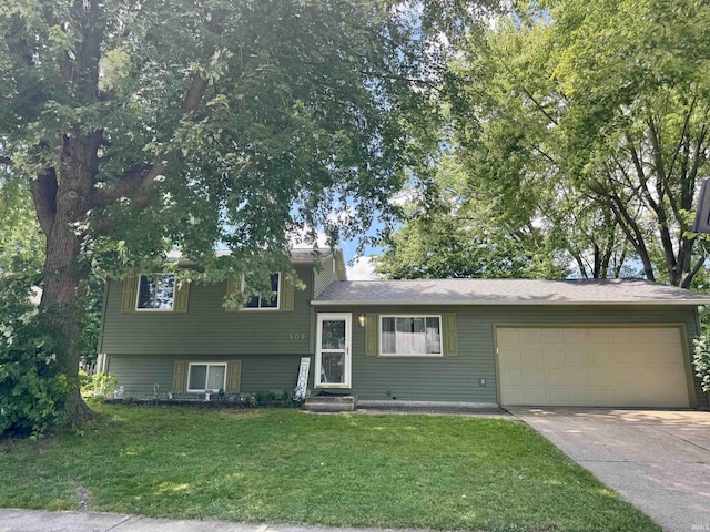 609 Stickler Ave, Mishawaka, IN 46544 - split level home with a garage, concrete driveway, and a front yard