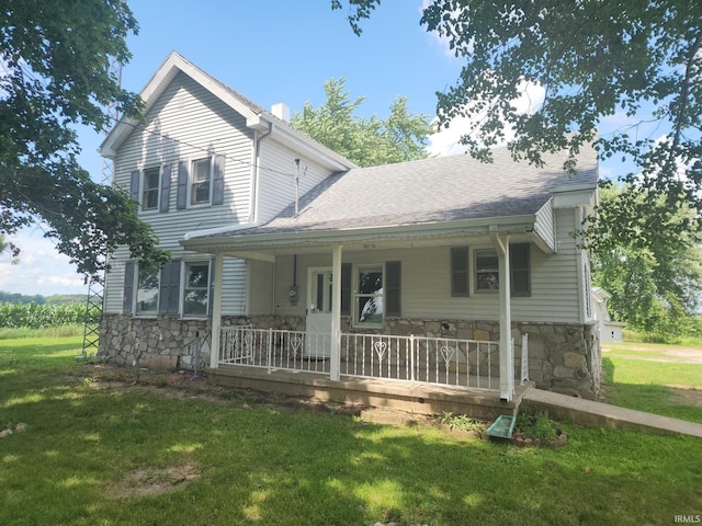 3742 N Indian Creek Rd, Logansport, IN 46947 - view of front of home featuring stone siding, a porch, a front yard, and a shingled roof