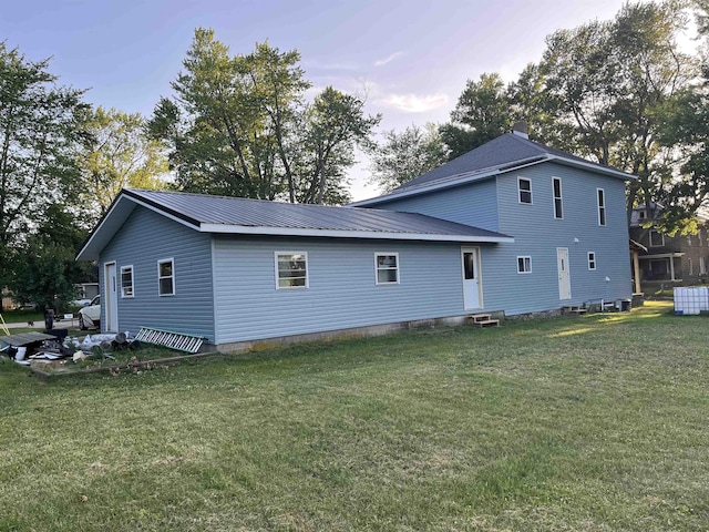 640 N Flint Rd, Angola, IN 46703 - back of house with entry steps, a lawn, and a metal roof