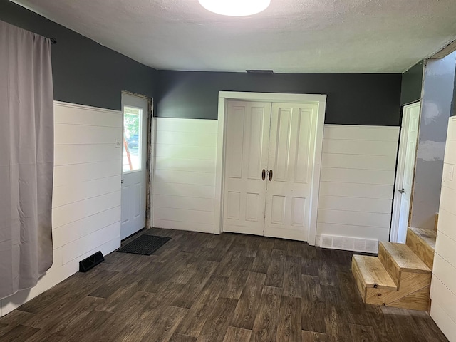 640 N Flint Rd, Angola, IN 46703 - foyer entrance with dark wood-style floors and a wainscoted wall