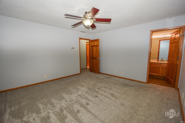 475 Gillcrest Dr, Albany, IN 47320 - unfurnished bedroom featuring carpet flooring, connected bathroom, a ceiling fan, and a textured ceiling