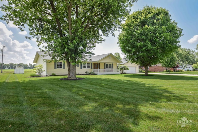 475 Gillcrest Dr, Albany, IN 47320 - view of front of home with a front yard, a porch, and an outbuilding