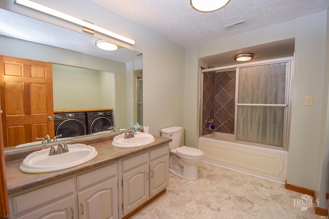 475 Gillcrest Dr, Albany, IN 47320 - bathroom featuring washing machine and clothes dryer, double vanity, bathing tub / shower combination, and a textured ceiling