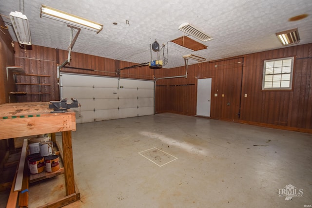 475 Gillcrest Dr, Albany, IN 47320 - garage featuring wood walls and a garage door opener