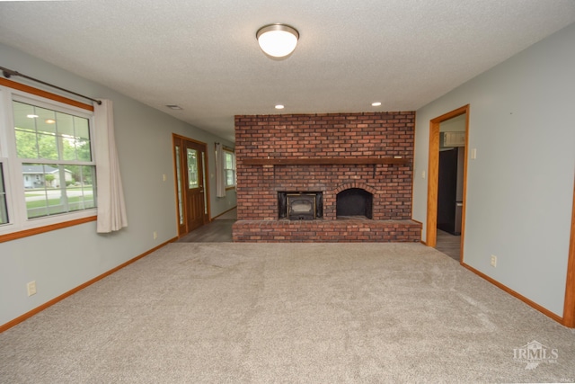 475 Gillcrest Dr, Albany, IN 47320 - unfurnished living room featuring carpet, a textured ceiling, and a brick fireplace