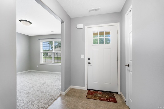 12216 Jacobas Pl, Fort Wayne, IN 46845 - carpeted entrance foyer with baseboards and tile patterned flooring