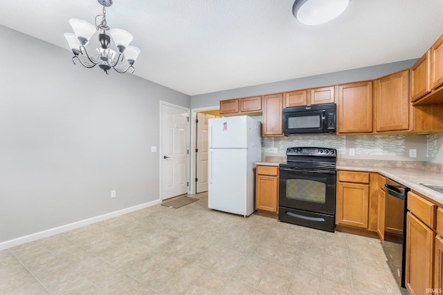 12216 Jacobas Pl, Fort Wayne, IN 46845 - kitchen with black appliances, light countertops, backsplash, a chandelier, and pendant lighting
