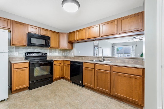 12216 Jacobas Pl, Fort Wayne, IN 46845 - kitchen with black appliances, light countertops, brown cabinets, and tasteful backsplash