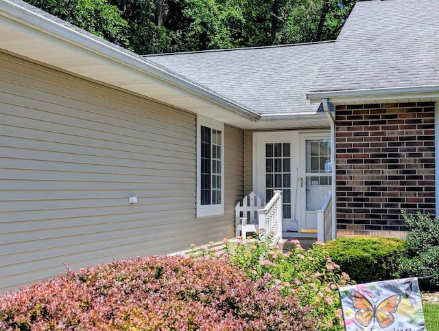 18485 Wooded Way S, Bend, IN 46637 - view of exterior entry featuring brick siding and roof with shingles
