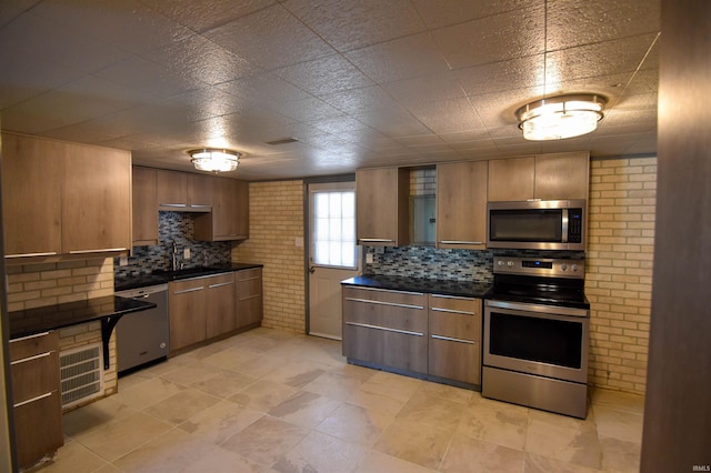 2625 S Ruston Ave, Evansville, IN 47714 - kitchen featuring appliances with stainless steel finishes, dark countertops, decorative backsplash, and modern cabinets