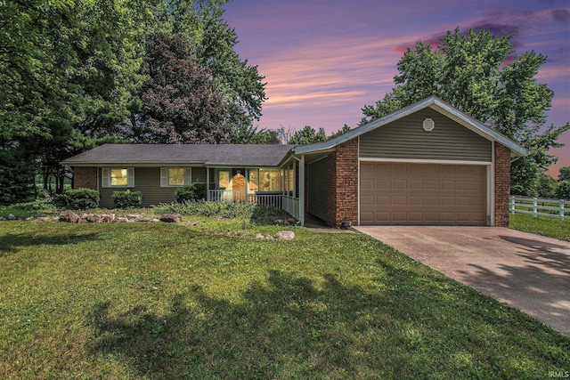 18055 Thomas Ln, Goshen, IN 46528 - ranch-style house with a garage, concrete driveway, a porch, and brick siding