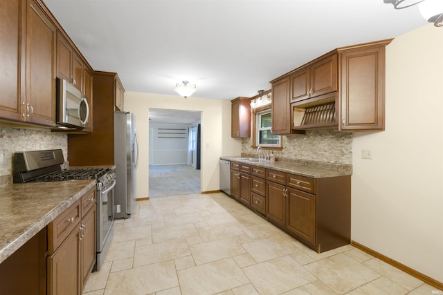 3617 Kirkfield Dr, Fort Wayne, IN 46815 - kitchen featuring stainless steel appliances, decorative backsplash, and brown cabinetry