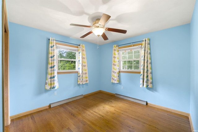 3617 Kirkfield Dr, Fort Wayne, IN 46815 - unfurnished room with a baseboard heating unit, plenty of natural light, and wood finished floors