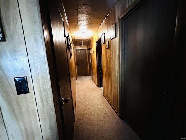 3886 N 1300 E, Loogootee, IN 47553 - hallway featuring attic access, light colored carpet, and wooden walls