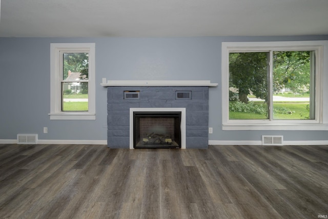 1201 Canal St, New Haven, IN 46774 - unfurnished living room with a tile fireplace and dark wood finished floors